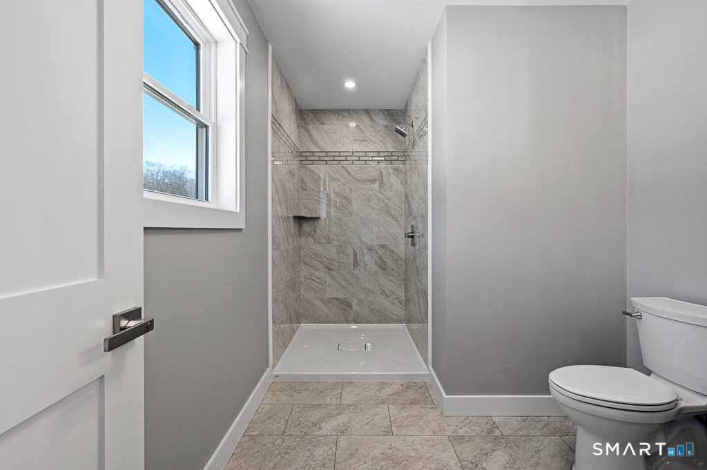 121 New Road Thompson, CT 06277 - Photo 21 of 40 a bathroom with a toilet and a shower