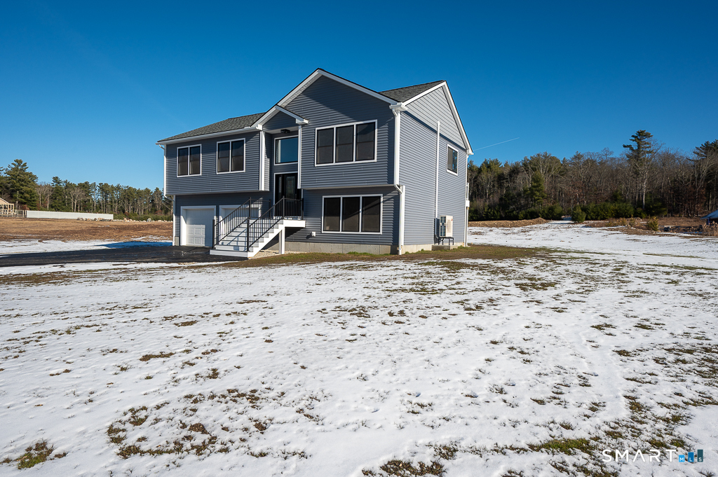 121 New Road Thompson, CT 06277 - Photo 3 of 40 a front view of a house with a yard