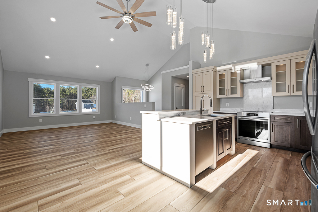 121 New Road Thompson, CT 06277 - Photo 7 of 40 a kitchen with stainless steel appliances granite countertop a stove and a large window