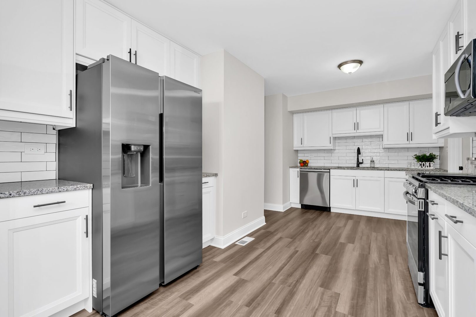 5332 Crescent Lane, Unit D Oak Forest, IL 60452 - Photo 6 of 17 a kitchen with stainless steel appliances a refrigerator sink and cabinets