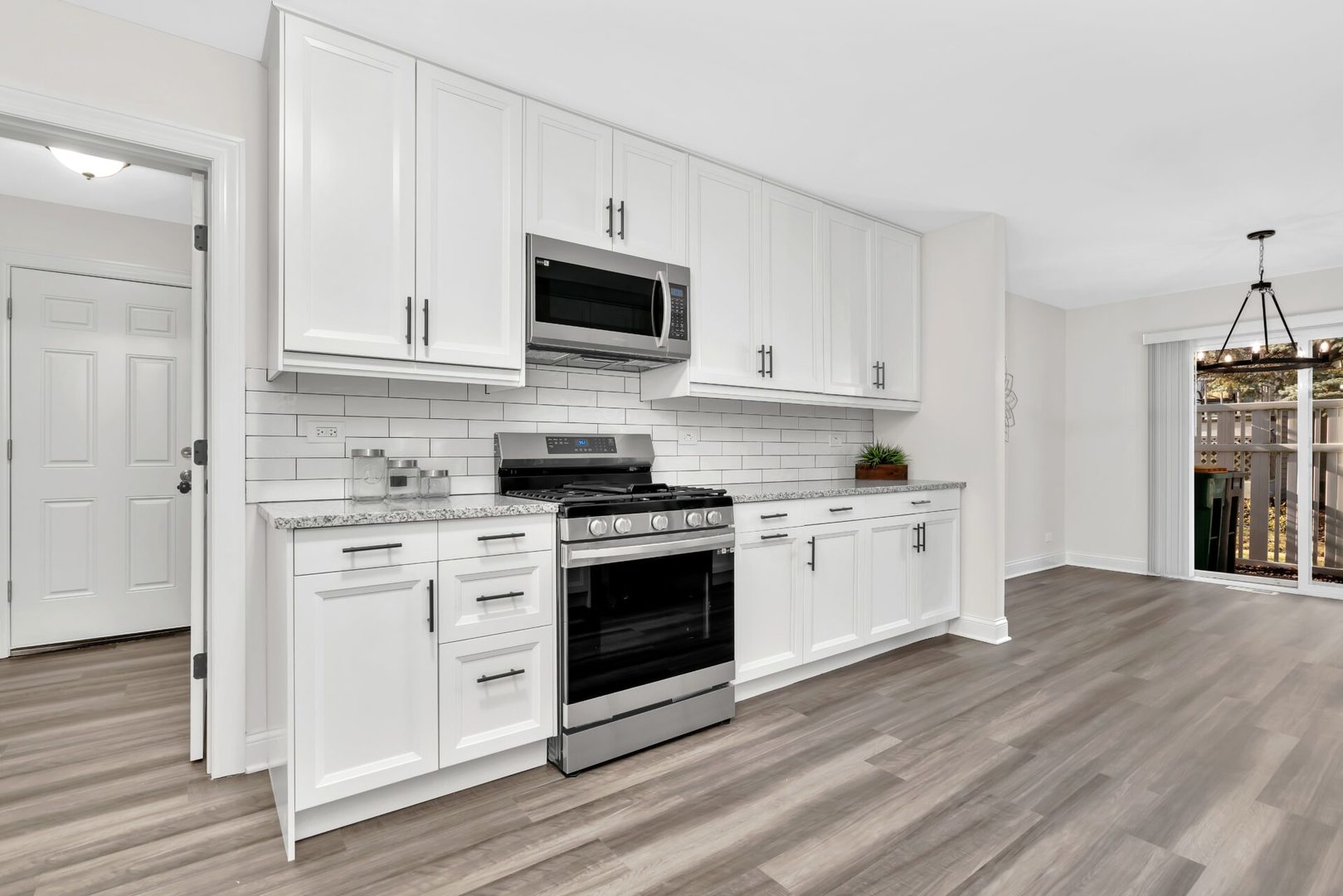 5332 Crescent Lane, Unit D Oak Forest, IL 60452 - Photo 8 of 17 a kitchen with stainless steel appliances white cabinets and a stove top oven