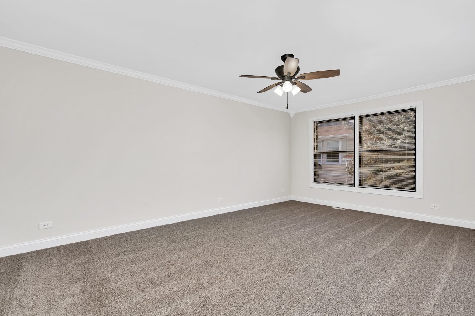 5332 Crescent Lane, Unit D Oak Forest, IL 60452 - Photo 9 of 17 a view of a room with a ceiling fan and carpet