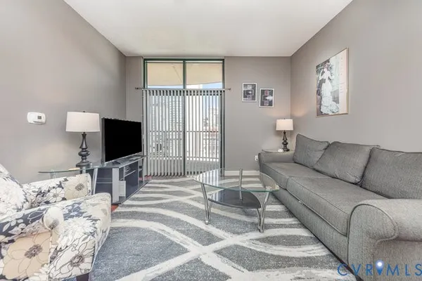 a living room with furniture and a flat screen tv