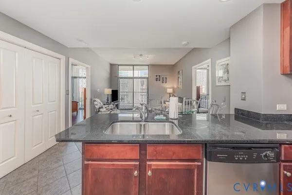 a kitchen with granite countertop a sink and cabinets
