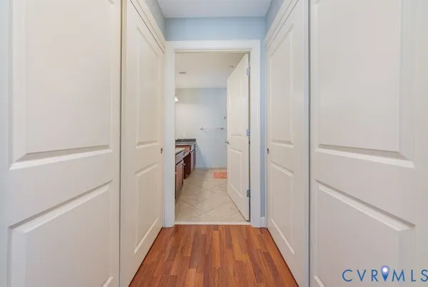 a view of a hallway with wooden floor