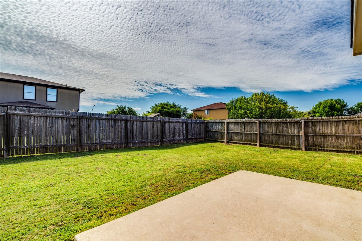 100 Easy Street Hutto, TX 78634 - Photo 26 of 36 A neatly maintained backyard offers ample space for outdoor enjoyment and recreation.