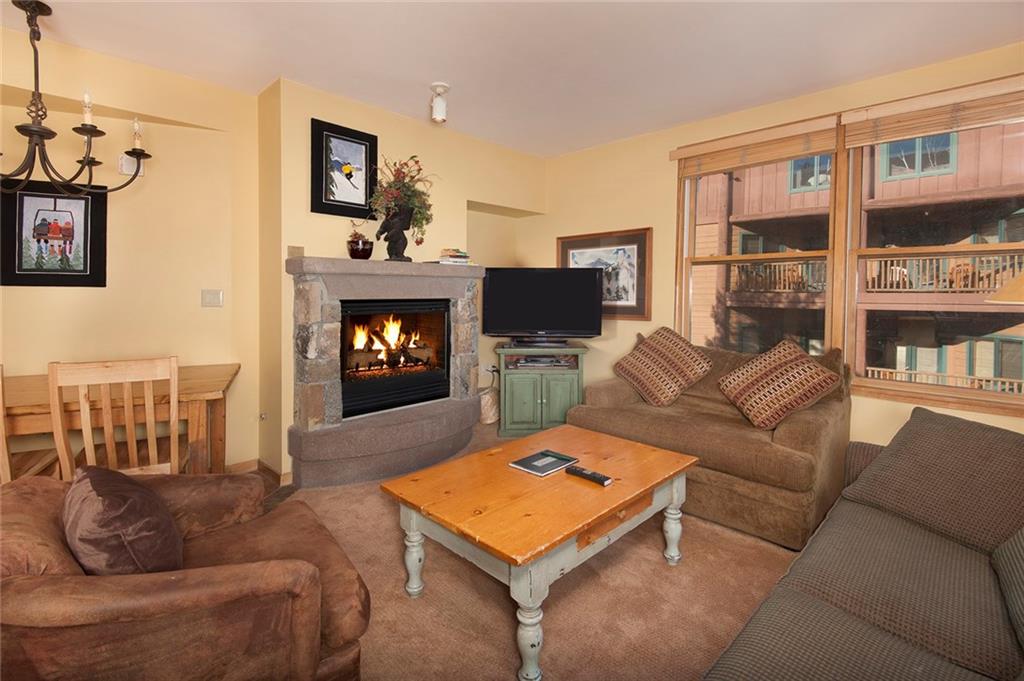 129 River Run Road, Unit 8063 Keystone, CO 80435 - Photo 1 of 23 a living room with furniture a fireplace and a flat screen tv