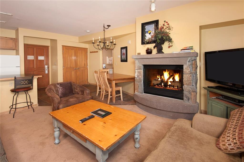 129 River Run Road, Unit 8063 Keystone, CO 80435 - Photo 2 of 23 a living room with furniture a flat screen tv and a fireplace