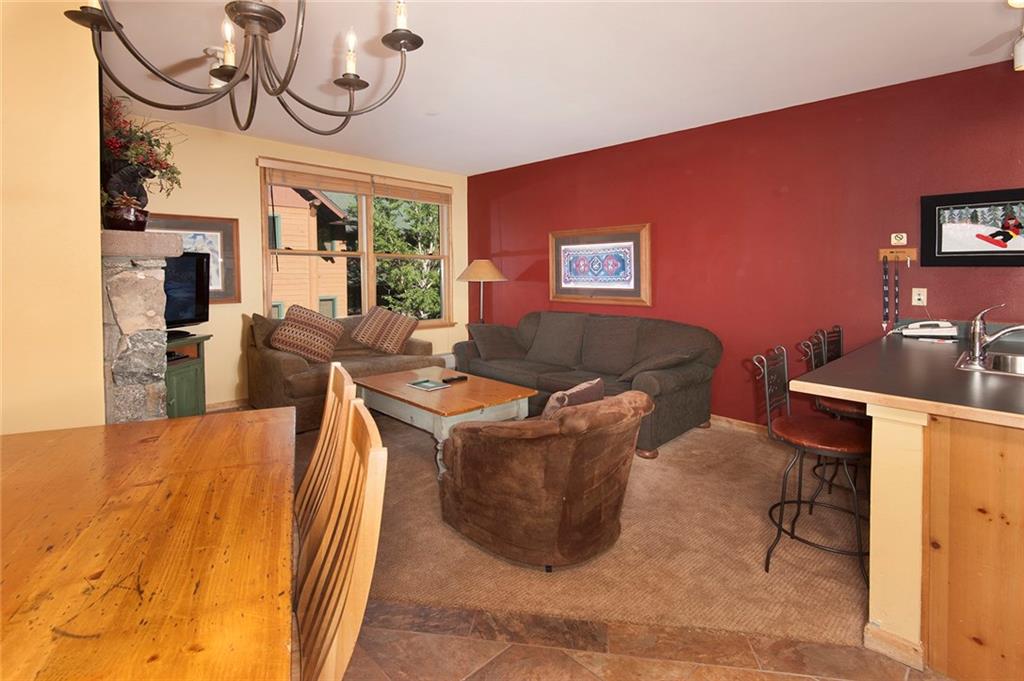 129 River Run Road, Unit 8063 Keystone, CO 80435 - Photo 11 of 23 a living room with furniture a fireplace and a chandelier