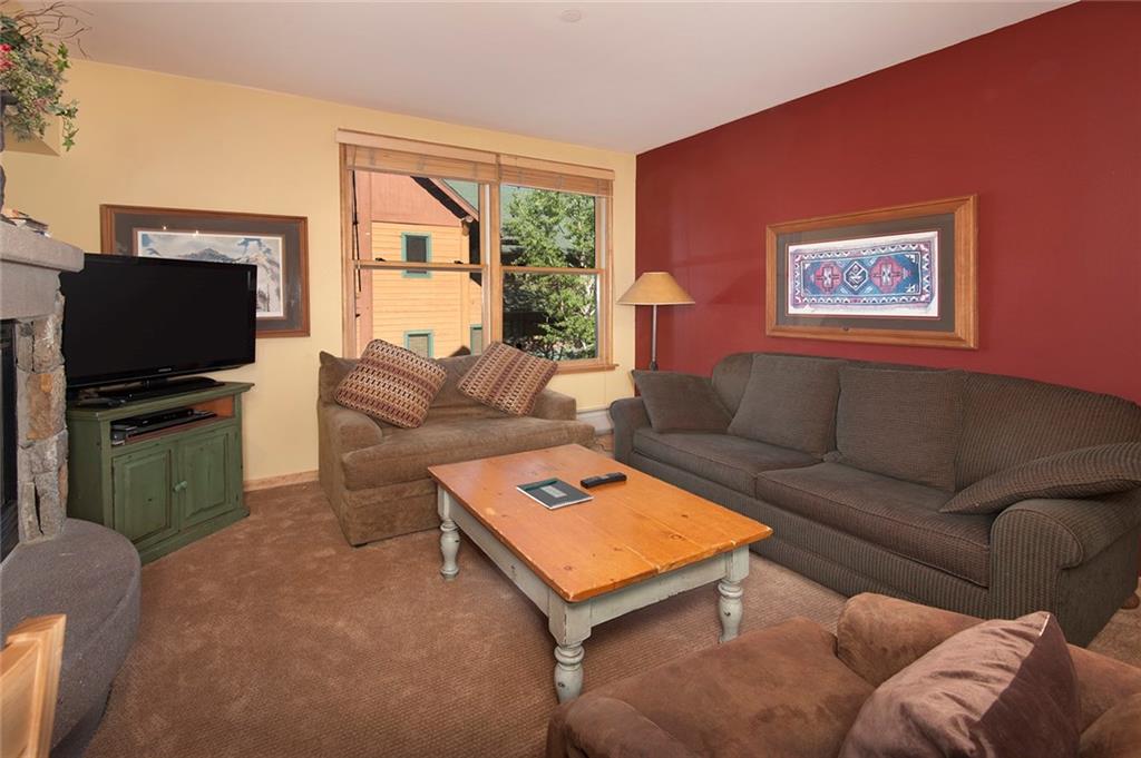 129 River Run Road, Unit 8063 Keystone, CO 80435 - Photo 3 of 23 a living room with furniture and a flat screen tv