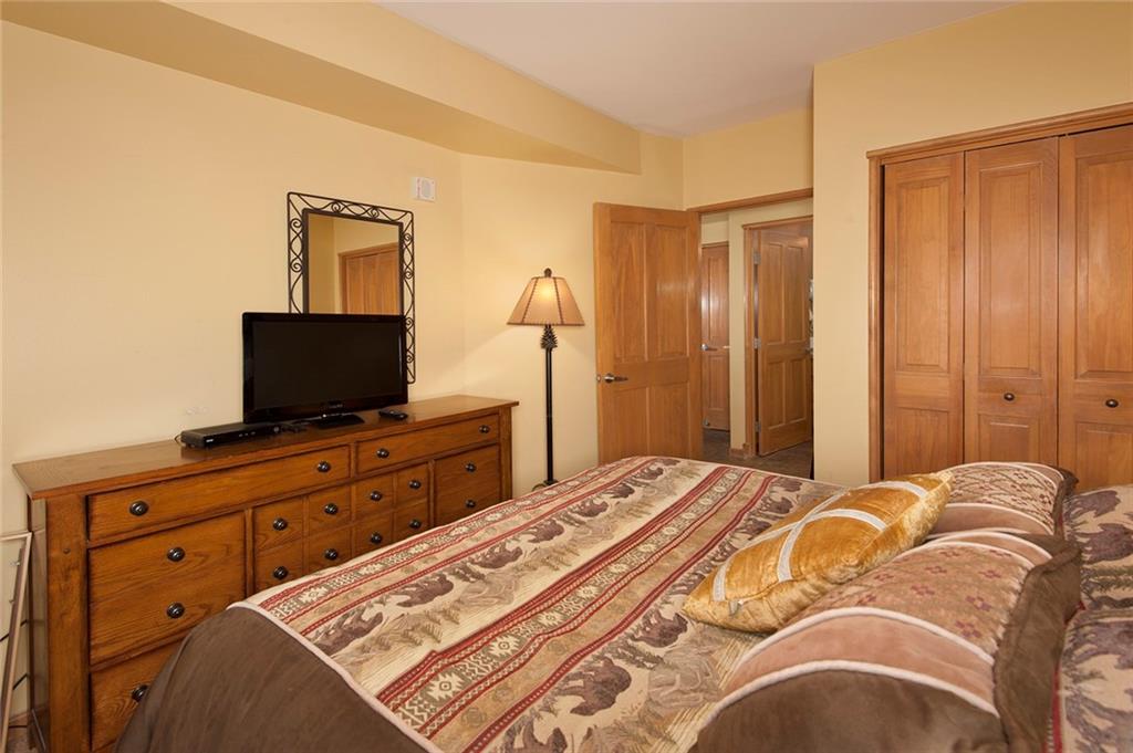 129 River Run Road, Unit 8063 Keystone, CO 80435 - Photo 6 of 23 a bedroom with a bed and a flat screen tv