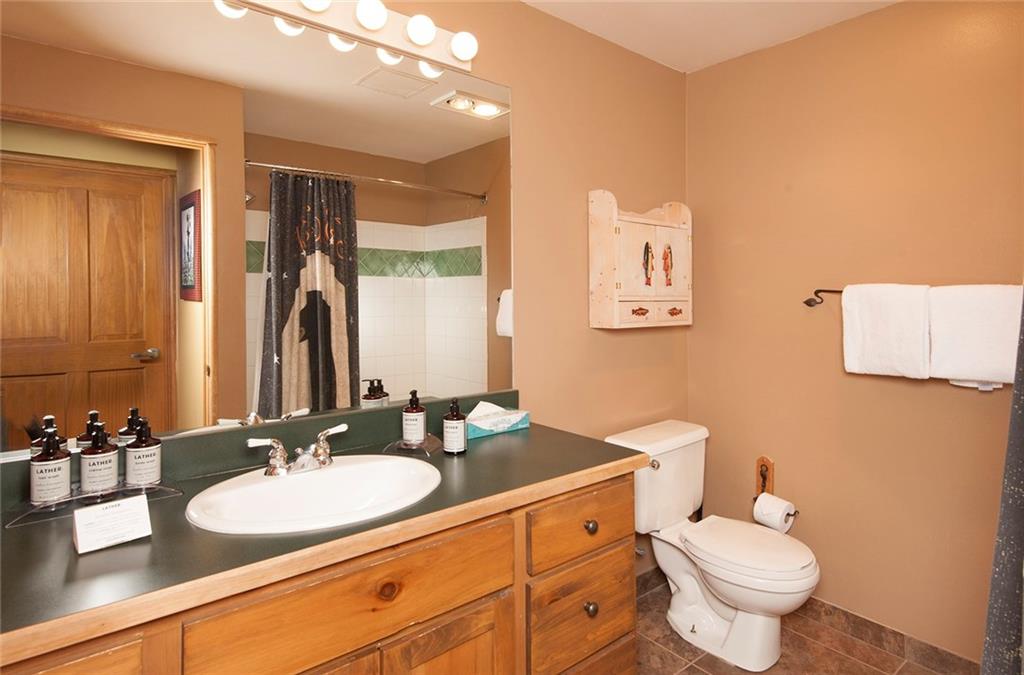 129 River Run Road, Unit 8063 Keystone, CO 80435 - Photo 8 of 23 a bathroom with a granite countertop sink mirror and toilet