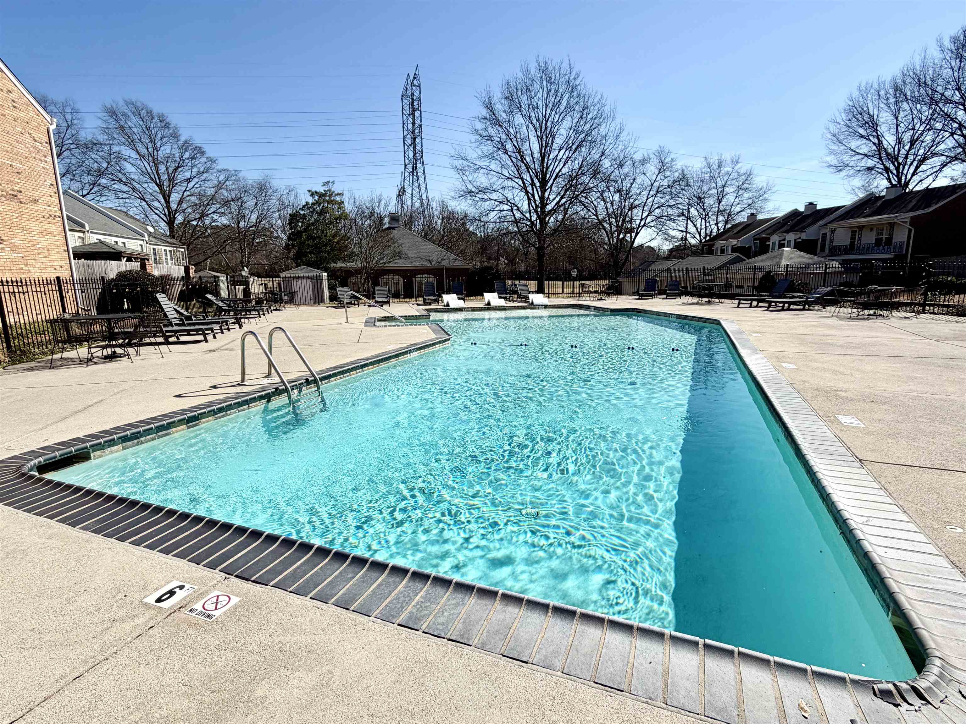 Community pool featuring a patio and a residential view