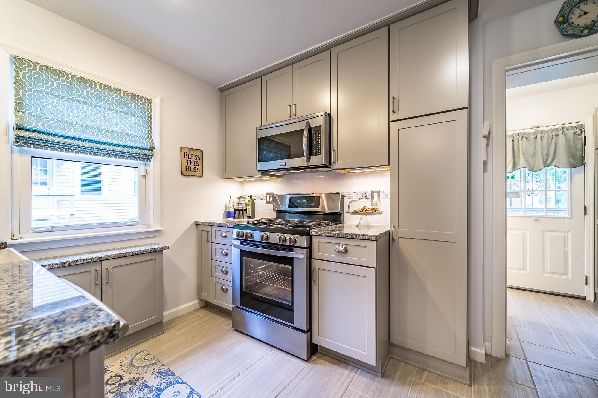 1603 Moffet Road Silver Spring, MD 20903 - Photo 11 of 30 a kitchen with stainless steel appliances granite countertop a refrigerator stove and sink