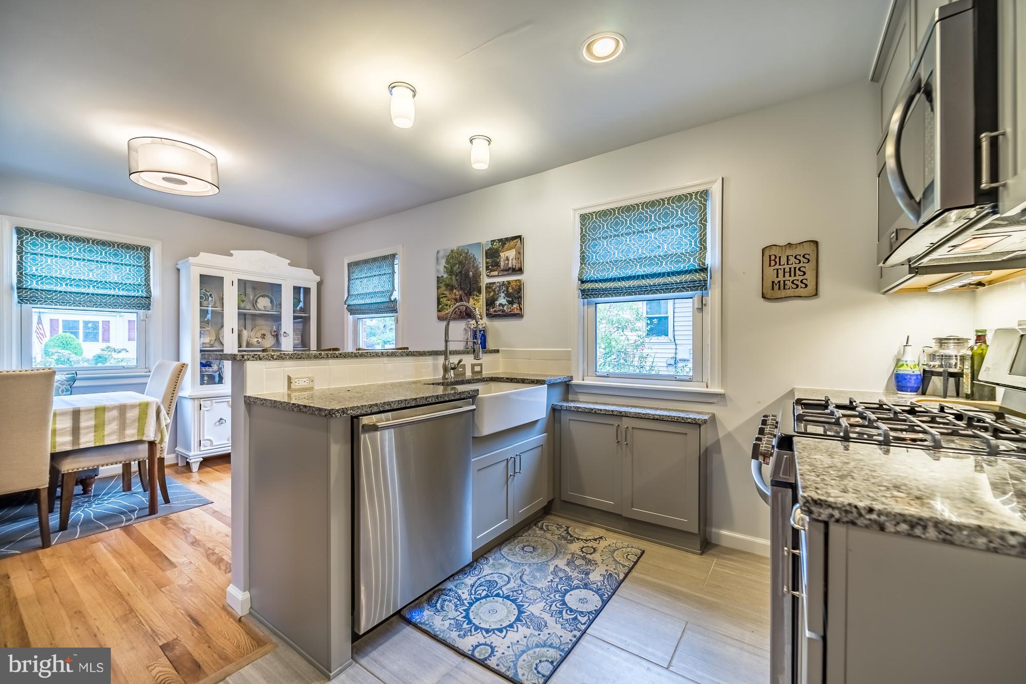 1603 Moffet Road Silver Spring, MD 20903 - Photo 12 of 30 a kitchen with granite countertop a sink stove and cabinets