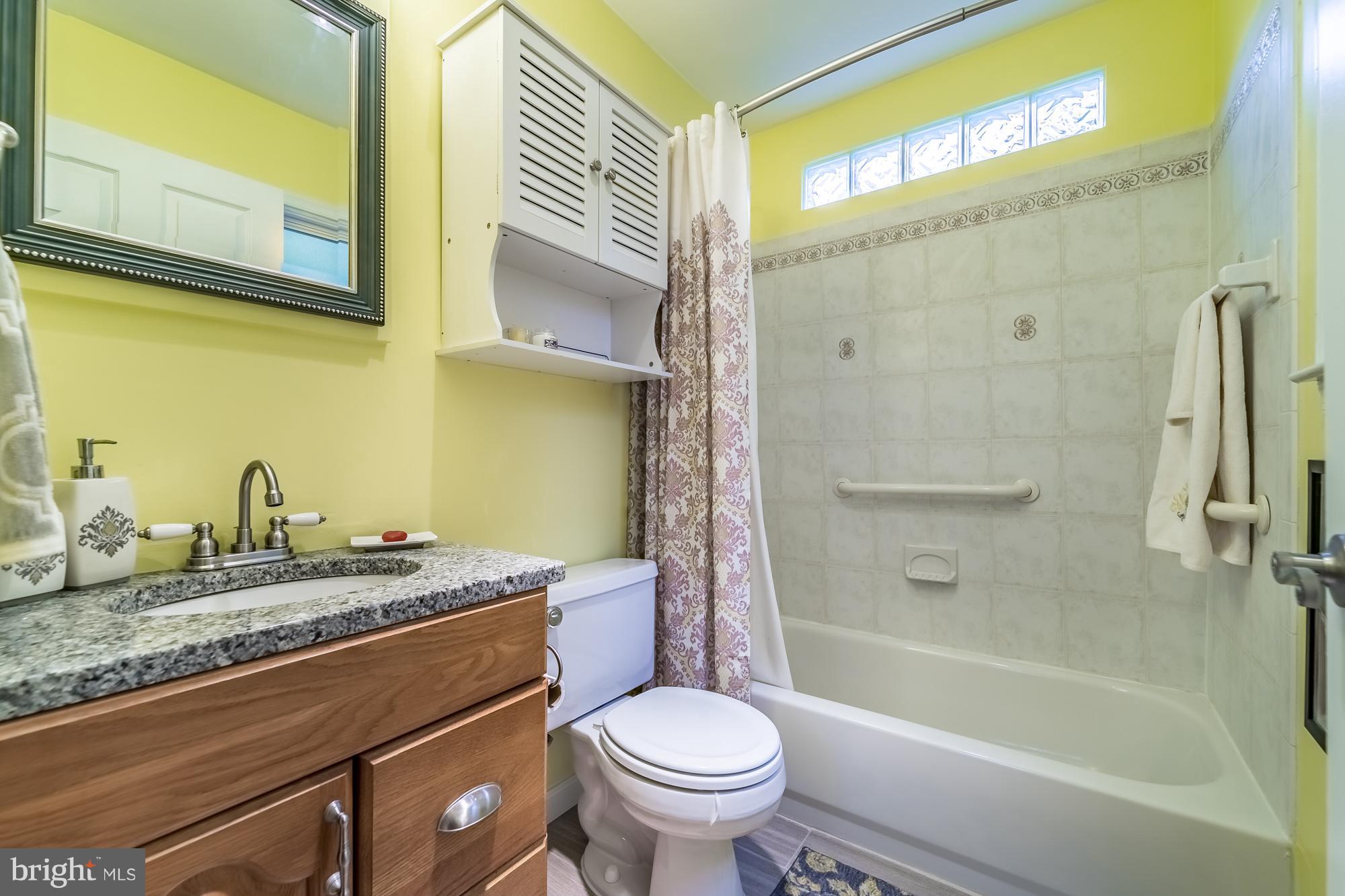 1603 Moffet Road Silver Spring, MD 20903 - Photo 14 of 30 a bathroom with a granite countertop sink toilet and shower