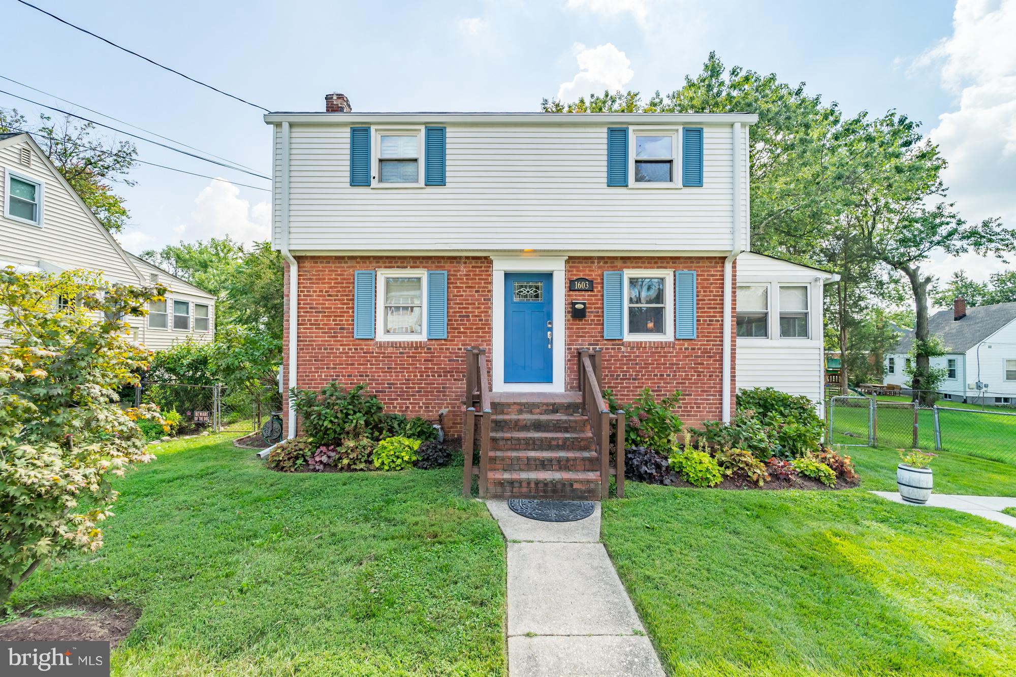 1603 Moffet Road Silver Spring, MD 20903 - Photo 4 of 30 a front view of a house with a garden and plants