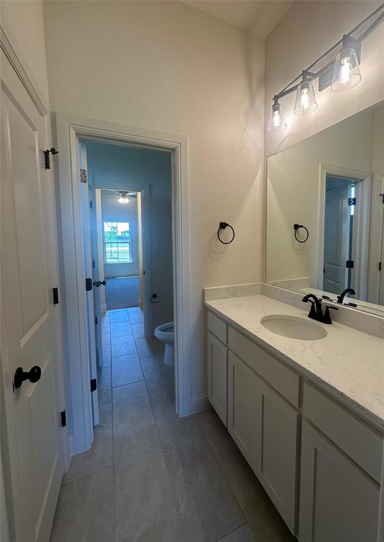 9424 Bluestem Lane DISH, TX 76247 - Photo 11 of 28 a bathroom with a double vanity sink and mirror with shower