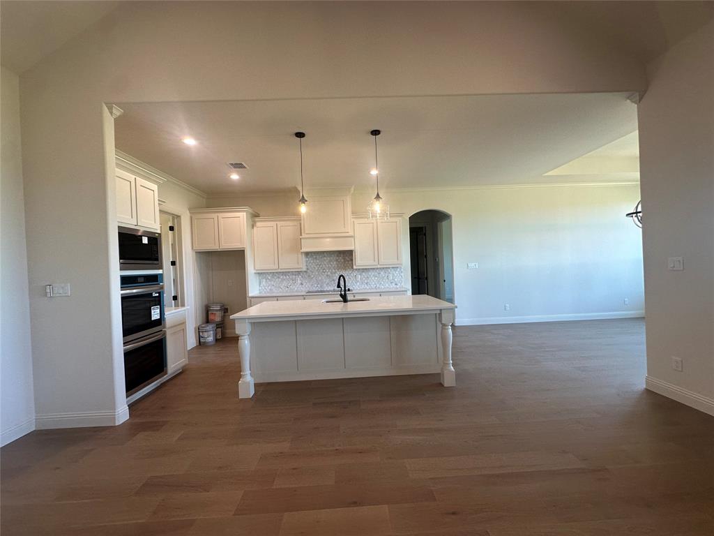 9424 Bluestem Lane DISH, TX 76247 - Photo 14 of 28 a large kitchen with kitchen island a sink stainless steel appliances and cabinets