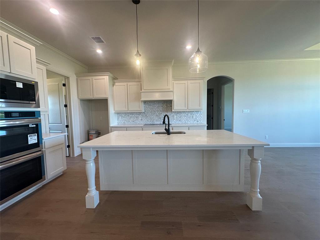 9424 Bluestem Lane DISH, TX 76247 - Photo 15 of 28 a large kitchen with kitchen island a sink stainless steel appliances and cabinets