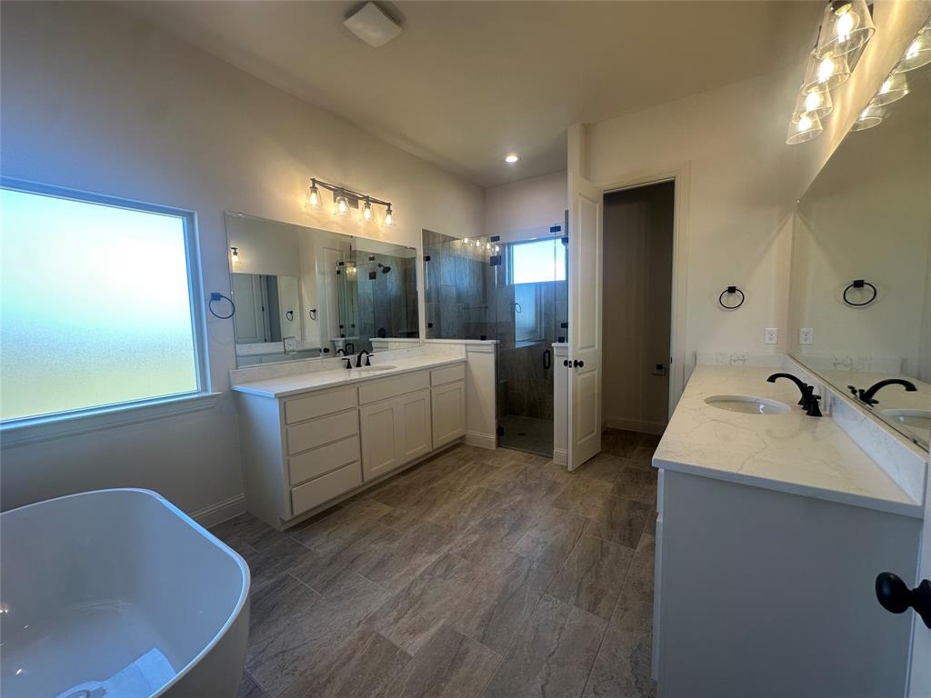 9424 Bluestem Lane DISH, TX 76247 - Photo 22 of 28 a bathroom with a sink and mirror with bathtub