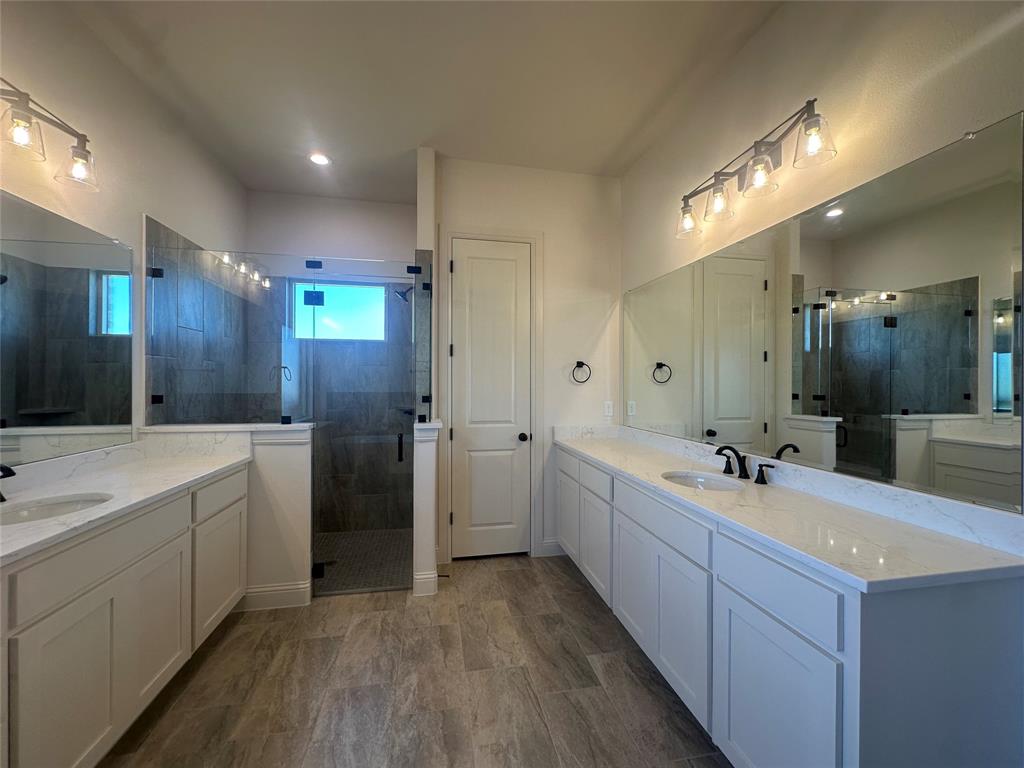 9424 Bluestem Lane DISH, TX 76247 - Photo 23 of 28 a bathroom with a double vanity sink mirror and shower
