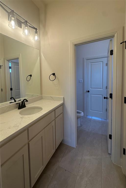 9424 Bluestem Lane DISH, TX 76247 - Photo 9 of 28 a bathroom with a double vanity sink and mirror