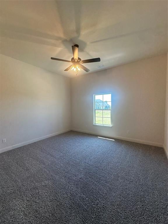 9424 Bluestem Lane DISH, TX 76247 - Photo 10 of 28 an empty room with a window and a fan