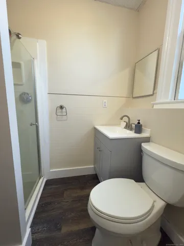 a white toilet sitting next to a bathroom sink