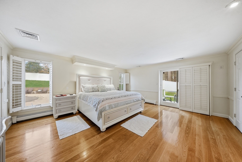 329 Orchard Street Millis, MA 02054 - Photo 12 of 42 a spacious bedroom with a bed and wooden floor