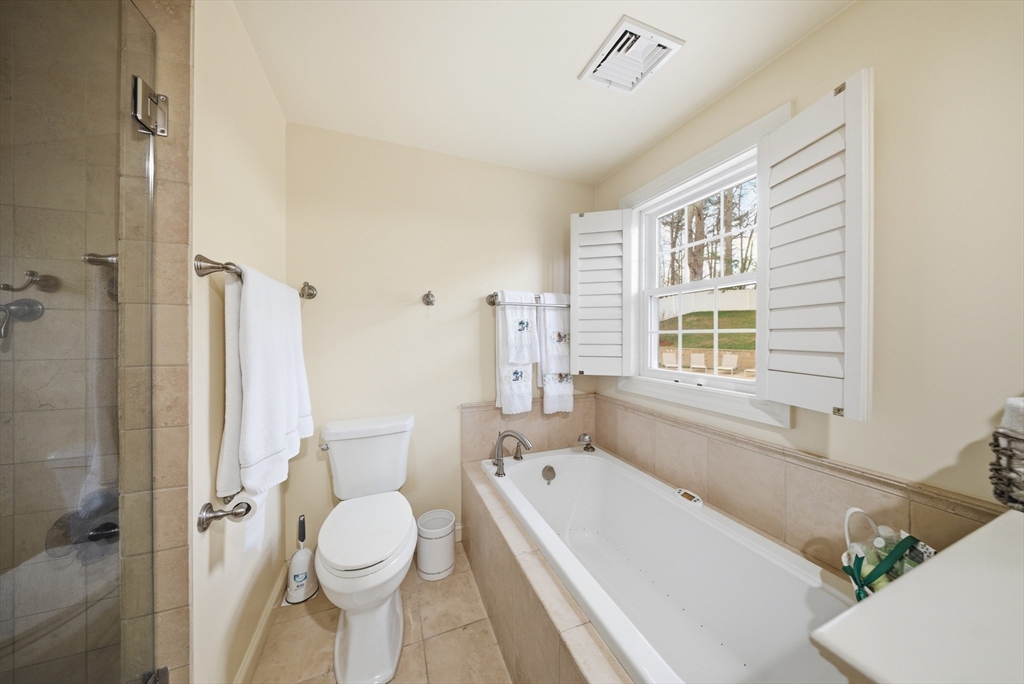 329 Orchard Street Millis, MA 02054 - Photo 15 of 42 a bathroom with a granite countertop toilet a sink and a bathtub