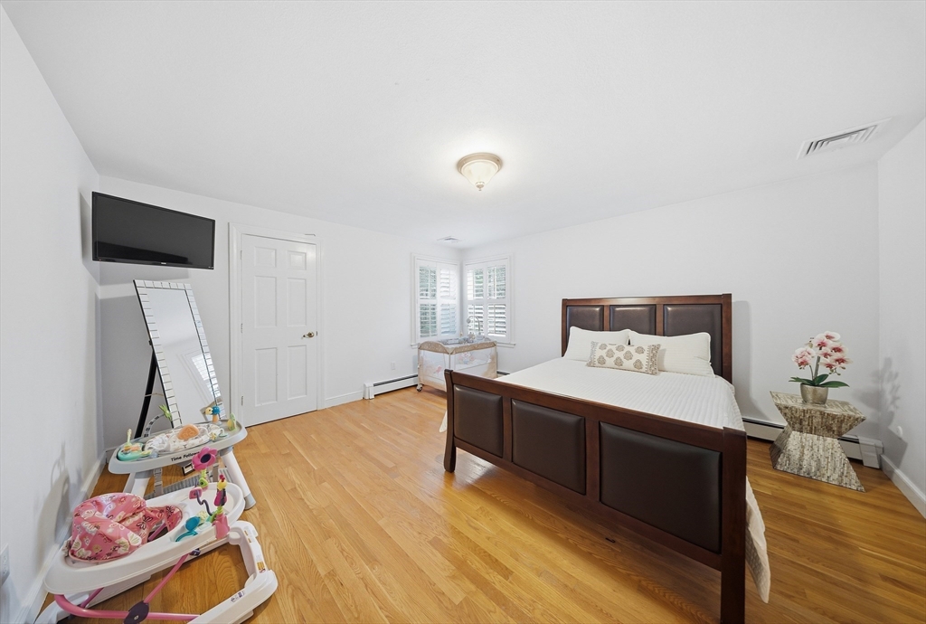 329 Orchard Street Millis, MA 02054 - Photo 16 of 42 a bedroom with a bed and flat screen tv
