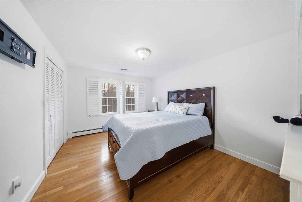329 Orchard Street Millis, MA 02054 - Photo 19 of 42 a bedroom with a bed and wooden floor