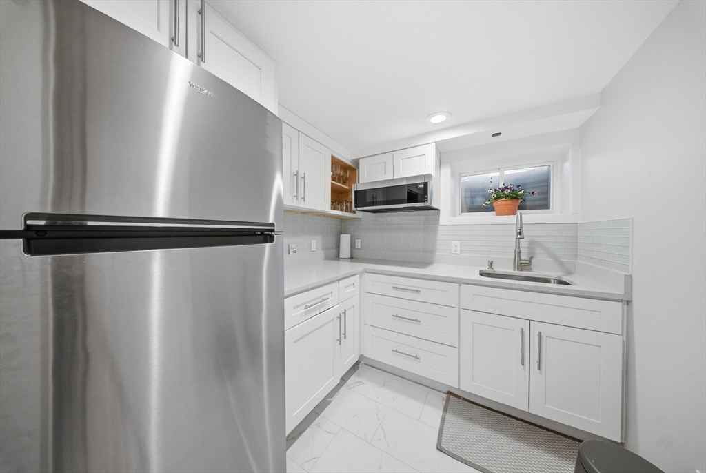 329 Orchard Street Millis, MA 02054 - Photo 29 of 42 a kitchen with white cabinets and sink