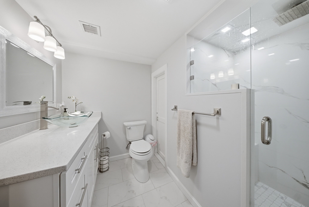 329 Orchard Street Millis, MA 02054 - Photo 30 of 42 a bathroom with a double vanity sink toilet and shower