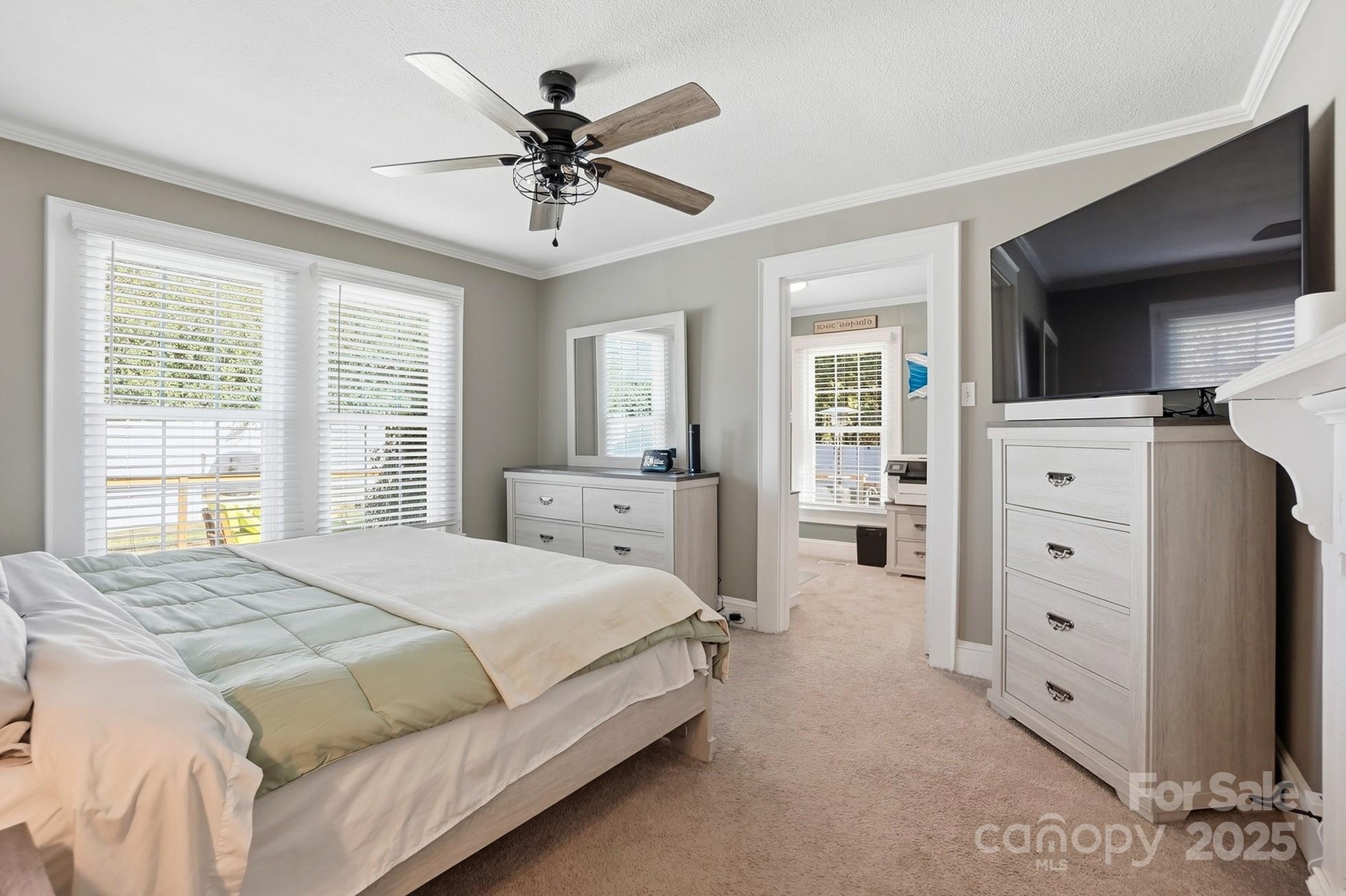 708 Mable Avenue Kannapolis, NC 28083 - Photo 18 of 48 a spacious bedroom with a large bed and a chandelier