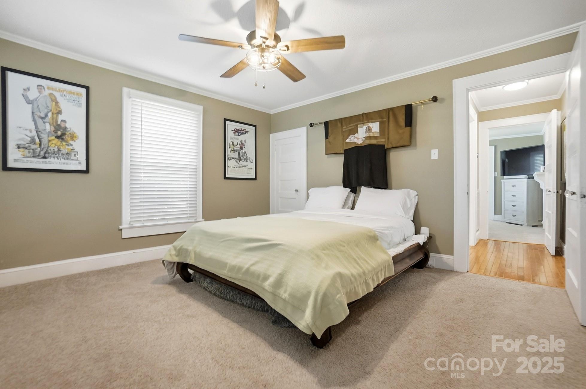 708 Mable Avenue Kannapolis, NC 28083 - Photo 24 of 48 a bedroom with a large bed and a chandelier