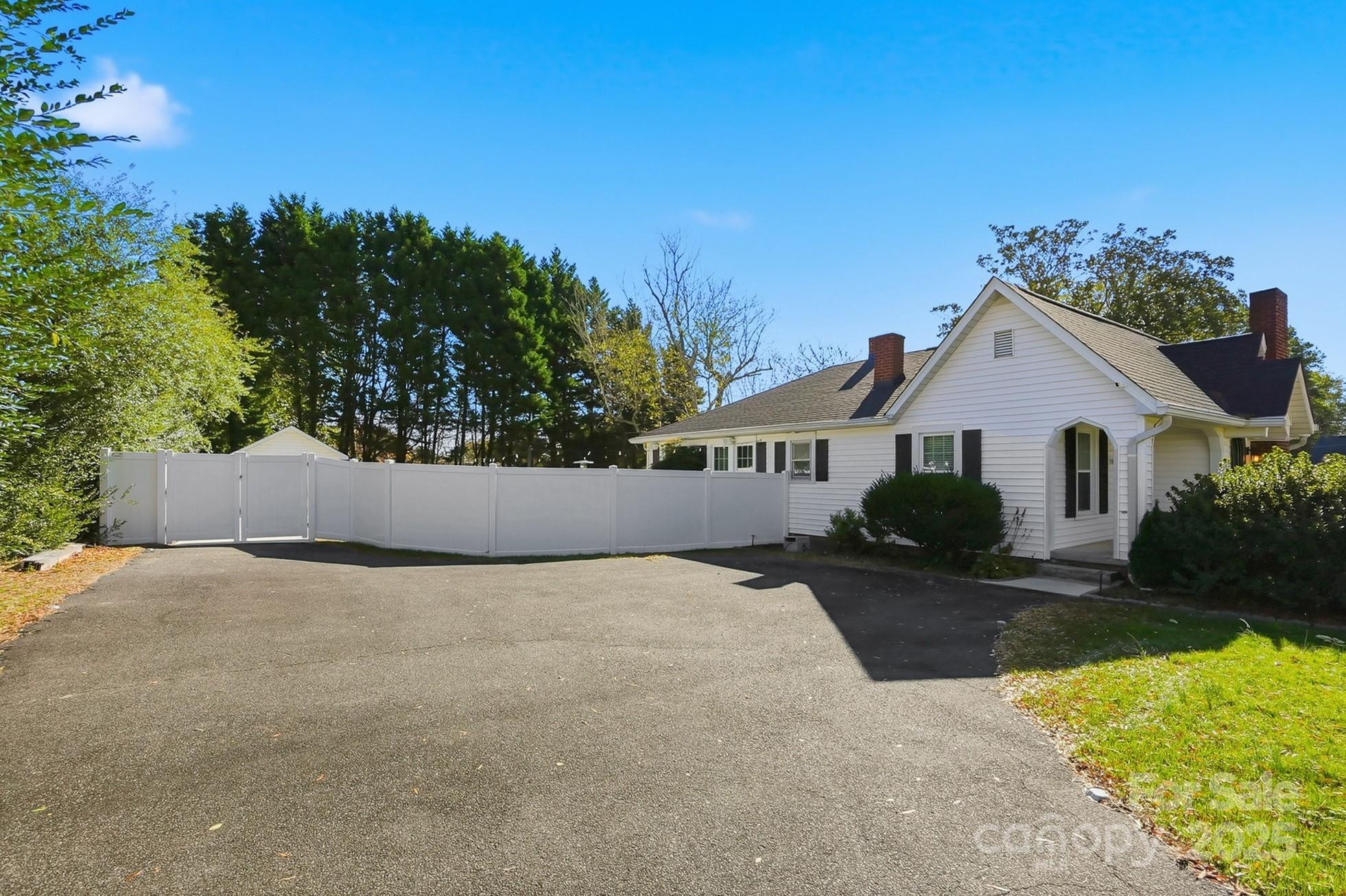 708 Mable Avenue Kannapolis, NC 28083 - Photo 47 of 48 a view of a white house with a yard and potted plants