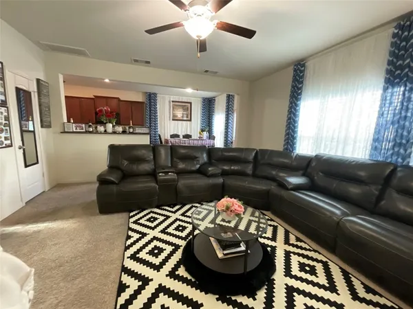 a living room with furniture rug and window