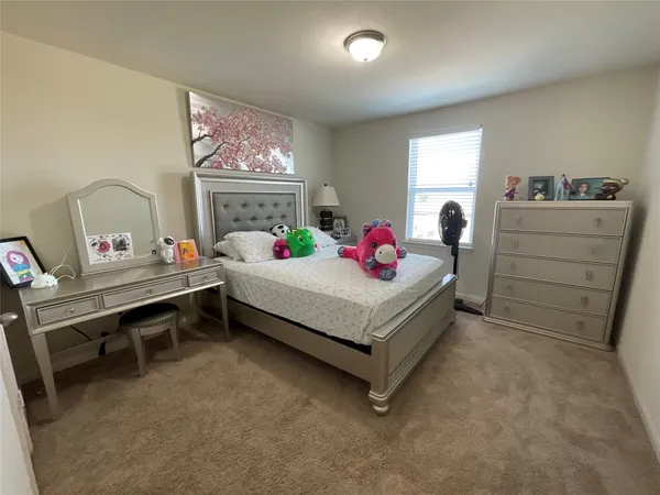 a bedroom with a bed and a table in it