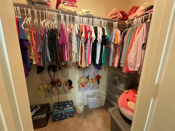 a bedroom with a bed and a dresser in it