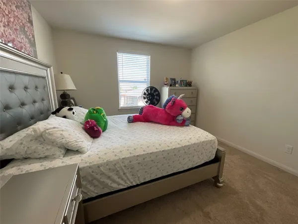 a view of walk in closet with clothes