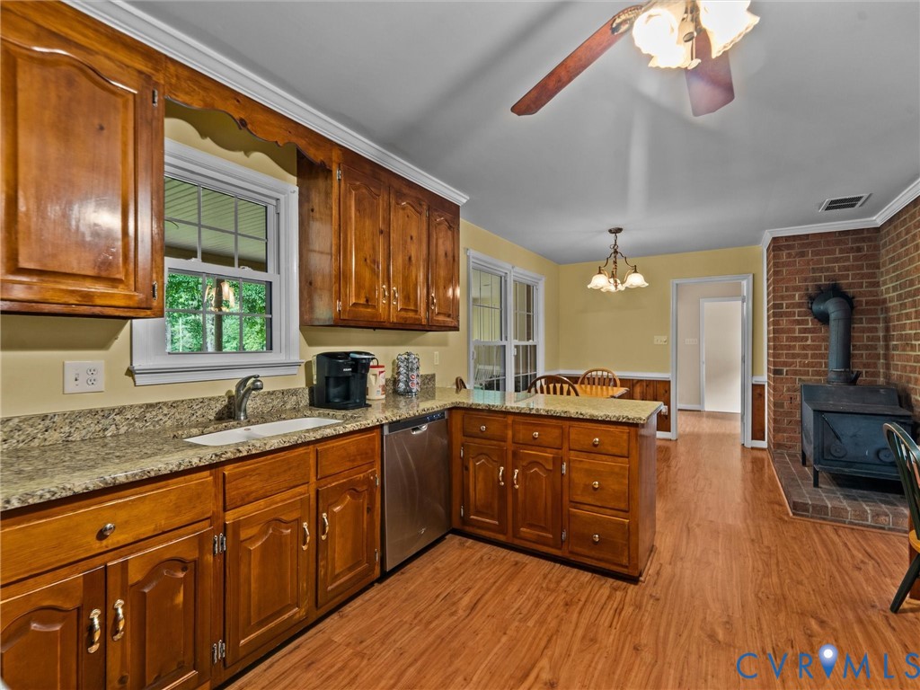 3420 State Rte 656 Powhatan, VA 23139 - Photo 12 of 37 a kitchen with stainless steel appliances granite countertop wooden floors a stove top oven a sink and dishwasher with wooden floor