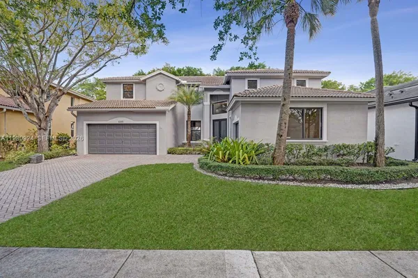 a front view of a house with a garden