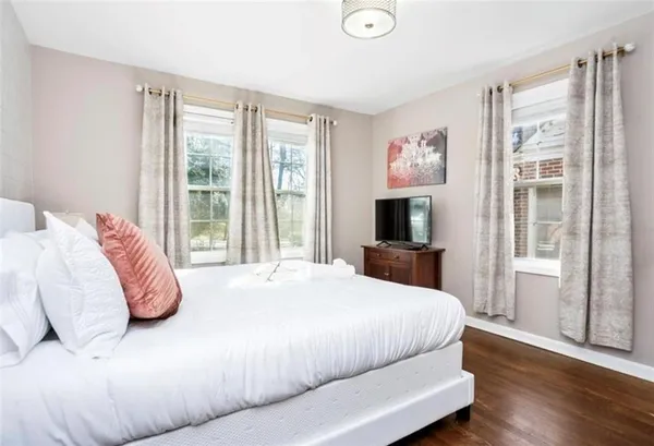 a bedroom with a large bed and a flat screen tv