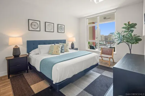 a bedroom with a large bed and a painting on the wall