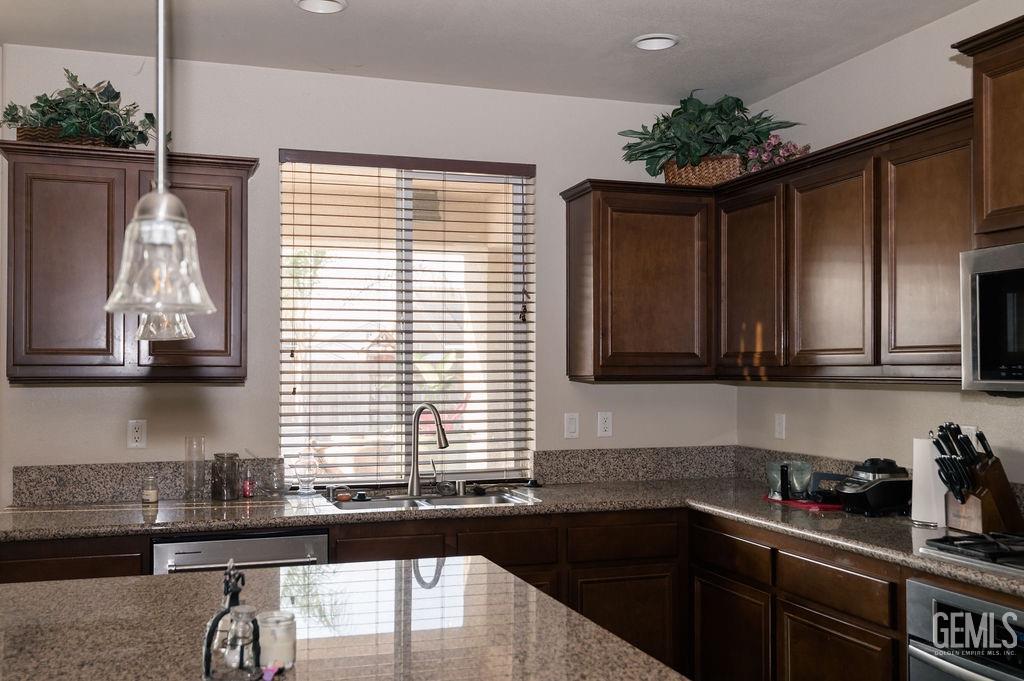 Undisclosed Address Bakersfield, CA 93314 - Photo 11 of 54 a kitchen with a sink and cabinets