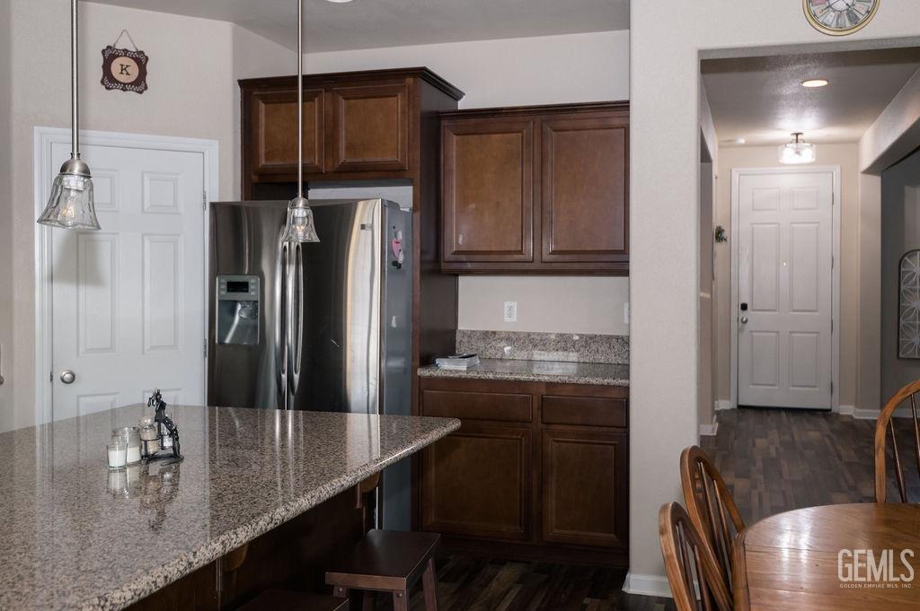 Undisclosed Address Bakersfield, CA 93314 - Photo 13 of 54 a kitchen with refrigerator and cabinets