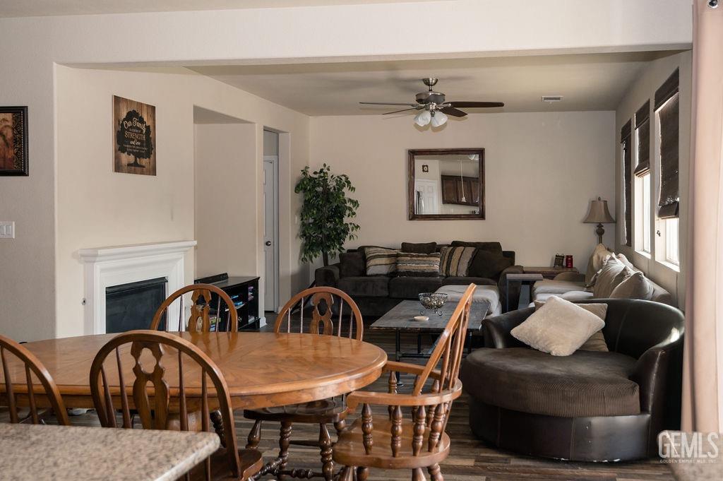 Undisclosed Address Bakersfield, CA 93314 - Photo 16 of 54 a living room with furniture a fireplace and potted plants