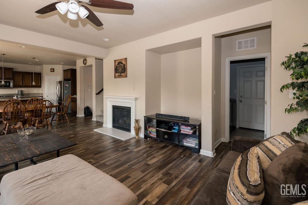 Undisclosed Address Bakersfield, CA 93314 - Photo 22 of 54 a living room with furniture a fireplace and a flat screen tv